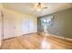 Bedroom featuring hardwood floors, a ceiling fan, and a closet with ample storage at 11462 W Tennessee Pl, Lakewood, CO 80226
