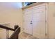 Entryway featuring double doors and a staircase with a dark brown handrail at 11462 W Tennessee Pl, Lakewood, CO 80226