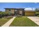 Two-story home with a brick and siding exterior, lush front lawn, and attached garage on a sunny day at 11462 W Tennessee Pl, Lakewood, CO 80226