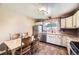 Cozy kitchen with tile floors, white cabinets, and dining set at 11462 W Tennessee Pl, Lakewood, CO 80226