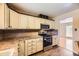 Traditional kitchen featuring light-colored cabinets, stylish backsplash, and stainless steel appliances at 11462 W Tennessee Pl, Lakewood, CO 80226