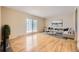Bright living room with hardwood floors, sliding glass doors and neutral decor is move-in ready at 11462 W Tennessee Pl, Lakewood, CO 80226