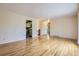 Open-concept living room with hardwood floors, and views of the entryway and kitchen, enhancing the sense of space at 11462 W Tennessee Pl, Lakewood, CO 80226