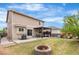 Expansive backyard featuring a patio, pergola, fire pit, lush lawn, and play set at 9535 Dexter Ln, Thornton, CO 80229