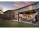 A serene backyard patio area with pergola, seating, and BBQ for outdoor relaxation and entertaining at 9535 Dexter Ln, Thornton, CO 80229