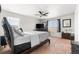 Primary bedroom features a ceiling fan, comfortable king bed, and windows that allow in natural light at 9535 Dexter Ln, Thornton, CO 80229