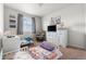 Bright bedroom with twin beds, a dresser with a TV, and charming decor for a cozy and inviting space at 9535 Dexter Ln, Thornton, CO 80229