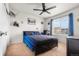 Well-lit bedroom features a modern black bed frame, a ceiling fan, and blue accents for a stylish design at 9535 Dexter Ln, Thornton, CO 80229