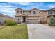 Two-story home showcasing neutral siding, a well-manicured lawn, and an attached two-car garage with a long driveway at 9535 Dexter Ln, Thornton, CO 80229