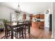 Eat-in kitchen featuring a dark wood table set, hardwood floors, and a center island at 9535 Dexter Ln, Thornton, CO 80229
