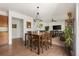 Bright living room and eat-in kitchen area features furniture, modern shelving, and wood flooring at 9535 Dexter Ln, Thornton, CO 80229