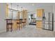 Modern bar area featuring a wine rack and stainless steel refrigerator at 11465 W Atlantic Ave, Lakewood, CO 80227