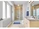 Bathroom features a tiled shower, single sink vanity, and a bright window at 11465 W Atlantic Ave, Lakewood, CO 80227