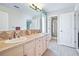 Bathroom features double sinks, tile countertops, and a large mirror, offering a functional and stylish space at 11465 W Atlantic Ave, Lakewood, CO 80227