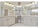 Elegant bathroom with dual vanities, tiled floors, and a luxurious walk-in shower at 11465 W Atlantic Ave, Lakewood, CO 80227