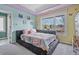 Bright bedroom with large window and unique bedframe and colorful decor at 11465 W Atlantic Ave, Lakewood, CO 80227