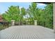 The wooden deck with black metal railings overlooks green trees and part of a community park at 11465 W Atlantic Ave, Lakewood, CO 80227