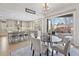 Open floor plan with dining area connected to the kitchen with quartz counters and seating at the kitchen island at 11465 W Atlantic Ave, Lakewood, CO 80227