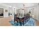 Elegant dining room featuring a modern light fixture and a large window providing ample natural light at 11465 W Atlantic Ave, Lakewood, CO 80227