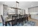 Elegant dining room featuring a wet bar, custom cabinetry, and designer light fixtures at 11465 W Atlantic Ave, Lakewood, CO 80227