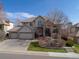 Stately two-story home with a three-car garage and beautifully landscaped front yard at 11465 W Atlantic Ave, Lakewood, CO 80227