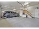 Spacious garage with epoxy flooring, custom storage cabinets, and ample room for parking at 11465 W Atlantic Ave, Lakewood, CO 80227