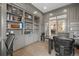 Well-appointed home office with custom built-in shelving and adjacent dining room access at 11465 W Atlantic Ave, Lakewood, CO 80227