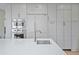 Contemporary kitchen featuring white countertops, gray cabinets, stainless steel appliances, and ample storage space at 11465 W Atlantic Ave, Lakewood, CO 80227