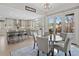 Modern kitchen with a large island, stainless steel appliances, and an adjacent breakfast nook at 11465 W Atlantic Ave, Lakewood, CO 80227