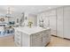 Open-concept kitchen with a large island, stainless steel appliances, and a seamless connection to the living area at 11465 W Atlantic Ave, Lakewood, CO 80227