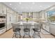 Modern kitchen with gray cabinets, an island with seating, and stainless steel appliances, perfect for cooking at 11465 W Atlantic Ave, Lakewood, CO 80227
