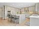 Spacious kitchen featuring stainless steel appliances, custom cabinets, and a large center island with seating at 11465 W Atlantic Ave, Lakewood, CO 80227