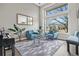 Inviting living room with stylish seating, a piano, and a view of the neighborhood at 11465 W Atlantic Ave, Lakewood, CO 80227