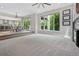 Bright living room featuring a large window, neutral decor, and an open floor plan leading to the kitchen and outdoor balcony at 11465 W Atlantic Ave, Lakewood, CO 80227