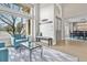 Bright living room with large windows, light wood floors, and comfortable blue seating at 11465 W Atlantic Ave, Lakewood, CO 80227