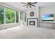 Bright living room with large windows, a modern fireplace, neutral paint, light-colored carpet, and recessed lighting at 11465 W Atlantic Ave, Lakewood, CO 80227