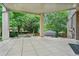 This covered patio has stone floors, a backyard fire pit, and a hot tub tucked in the corner at 11465 W Atlantic Ave, Lakewood, CO 80227