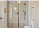 Modern bathroom shower featuring subway tile, glass door, and bronze fixtures, creating a sleek and sophisticated look at 11465 W Atlantic Ave, Lakewood, CO 80227