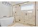 Modern bathroom features a luxurious soaking tub and a large walk-in shower with glass accents at 11465 W Atlantic Ave, Lakewood, CO 80227
