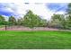 Well-maintained tennis court surrounded by lush landscaping, perfect for enjoying a match at 11465 W Atlantic Ave, Lakewood, CO 80227