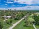 Beautiful community aerial view featuring a golf course, walking path, and buildings surrounded by green trees at 2525 S Dayton Way # 1510, Denver, CO 80231