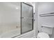 Bathroom featuring a bathtub and glass shower door at 2525 S Dayton Way # 1510, Denver, CO 80231