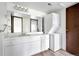Well-lit bathroom features a spacious vanity and a stacked washer/dryer at 2525 S Dayton Way # 1510, Denver, CO 80231