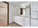 Bathroom with white vanity, shower, and stacked washer and dryer at 2525 S Dayton Way # 1510, Denver, CO 80231