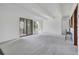 Spacious living room with neutral carpet, sliding glass doors and bar seating area at 2525 S Dayton Way # 1510, Denver, CO 80231