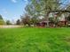 An expansive backyard featuring a lush lawn and mature trees at 5845 W Portland Dr, Littleton, CO 80128