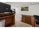 Finished basement area with a bar, wainscoting, and neutral carpeting provides extra living space at 5845 W Portland Dr, Littleton, CO 80128