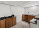 Basement bar area, complete with kitchenette and ample storage at 5845 W Portland Dr, Littleton, CO 80128