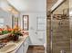 Updated bathroom with shower, modern tile, vanity and natural light at 5845 W Portland Dr, Littleton, CO 80128