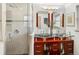 Bathroom with glass vessel sinks, modern fixtures, and a glass-enclosed shower with marble-like tile at 5845 W Portland Dr, Littleton, CO 80128